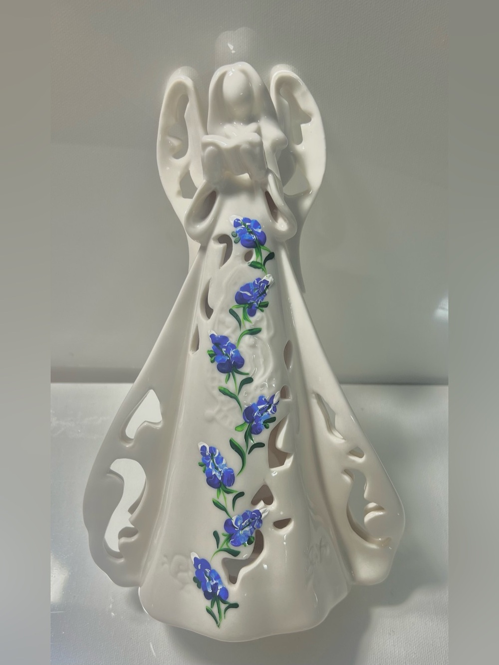 White Ceramic Angel Figurine with Blue Floral Accents